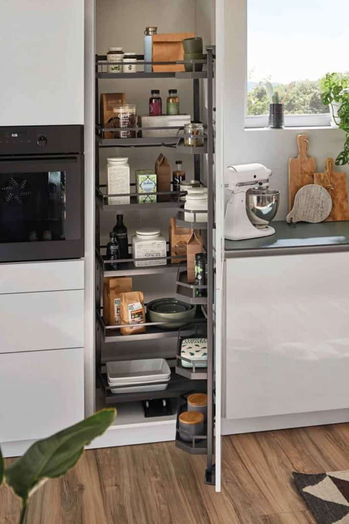 Alles ist bestens organisiert im Vorratsschrank. Der Stauraum teilt sich auf in Regale an der Türinnenseite und im Schrank selbst. Öffnet man die Tür, kommen einem die Tablare ein Stück entgegen. Auf diese Weise hat man alles gut im Blick. Die höheren Kanten verhindern, dass kleine Teile herausfallen. © AMK